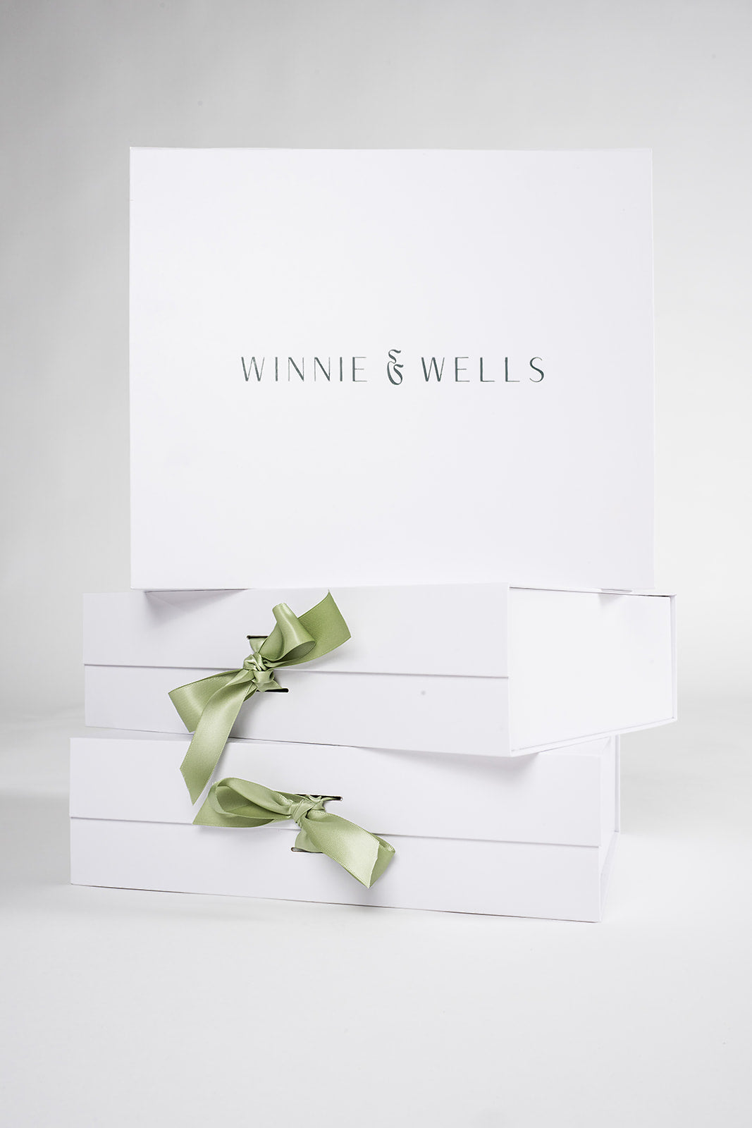 decorative image of stack of closed gift boxes with green ribbon