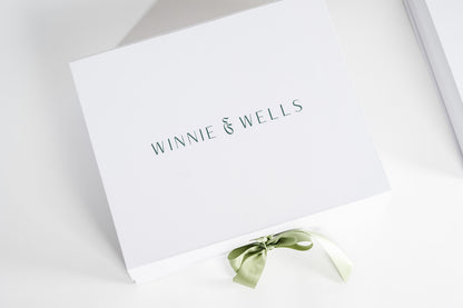 White box with 'Winnie & Wells' branding and a green ribbon on a light gray background