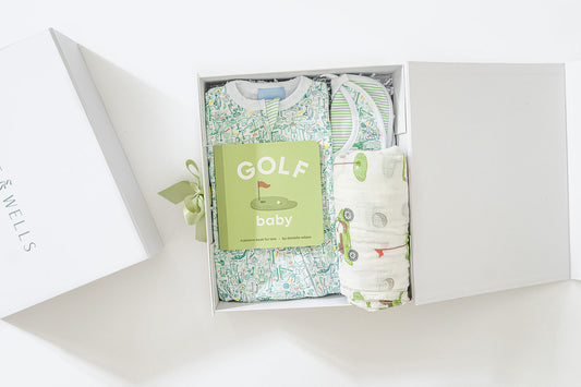 Baby clothing set with 'Golf' theme in a box on a white background